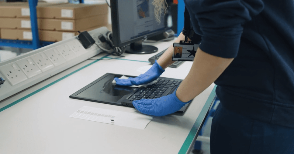 technician cleans laptop screen