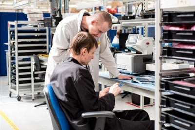 technicians check a returned mobile device (1)